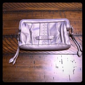 Pewter metallic leather Cole Haan zip clutch.